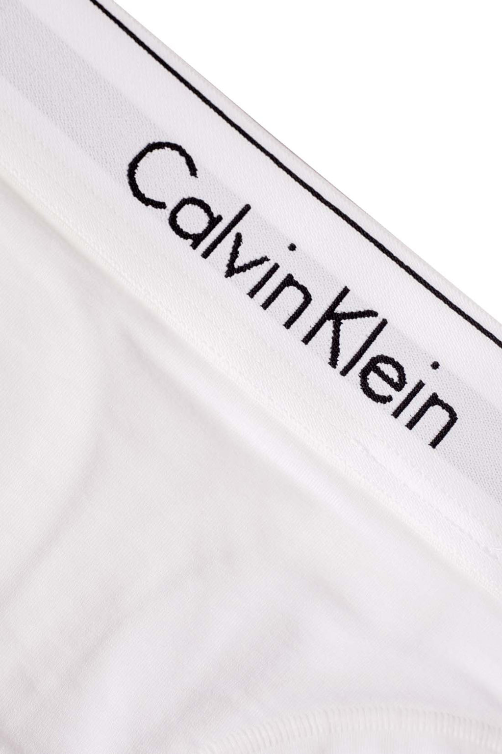 White women's cotton thong with a contrast elasticated logo waistband on a plain background. — view 6