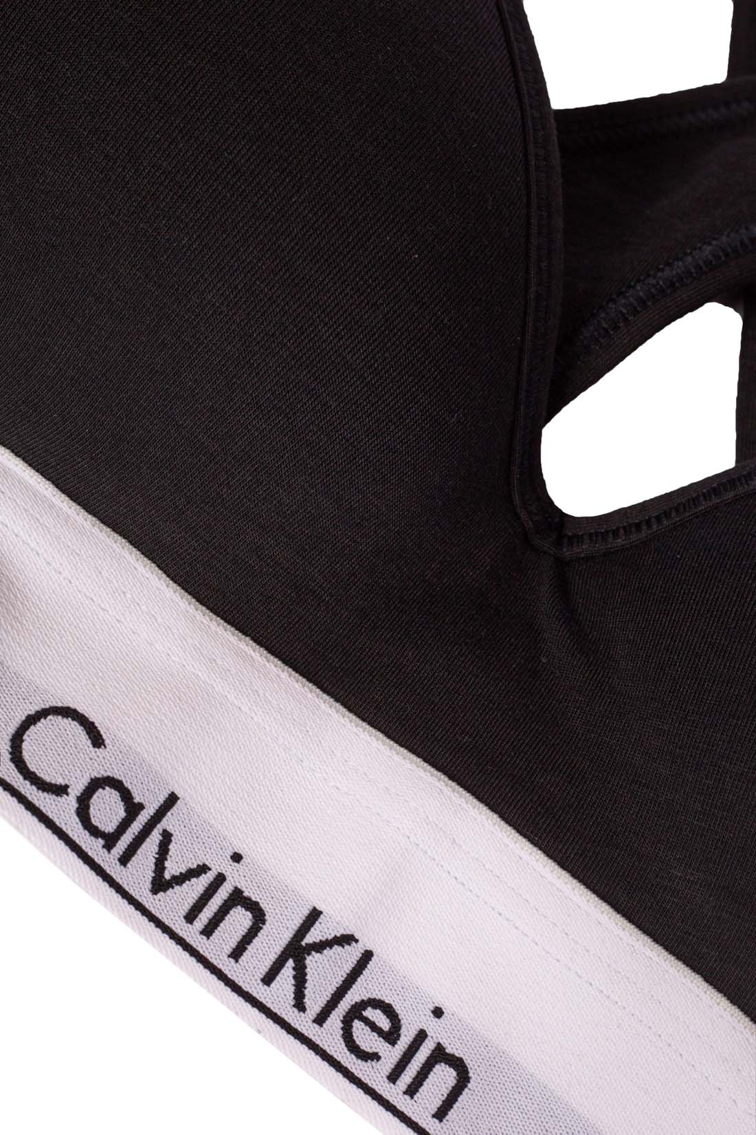 White women's v-neck bralette with crossover straps and contrasting elastic logo band — view 3