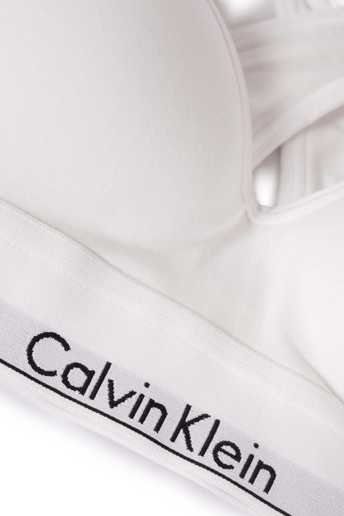 White women's v-neck bralette with crossover straps and contrasting elastic logo band — view 12