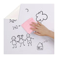 Clear dry erase whiteboard wall sticker unrolled on a flat surface, showing transparent plastic material.