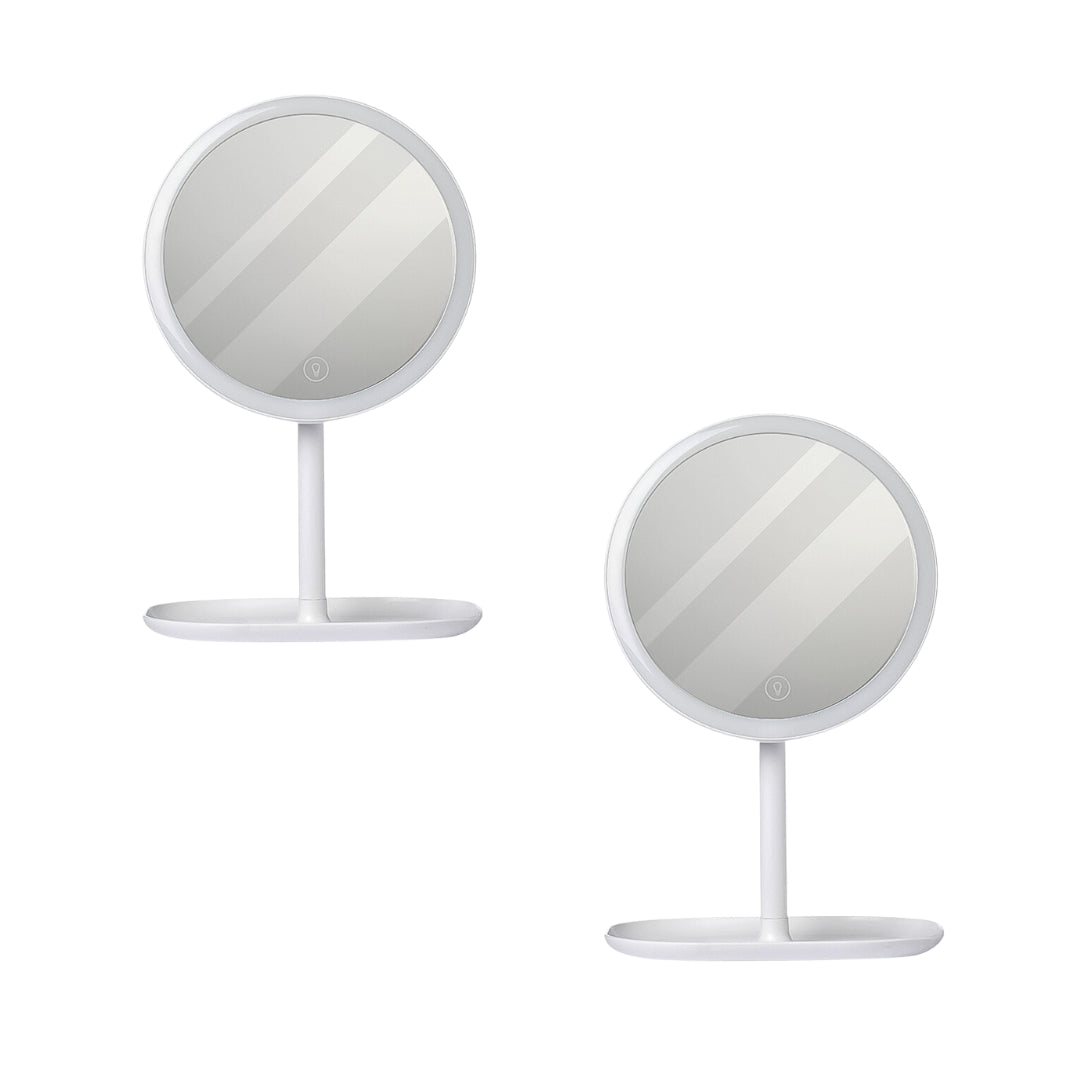 Two white round smart LED makeup vanity mirrors with adjustable tricolor lights on a bedroom table