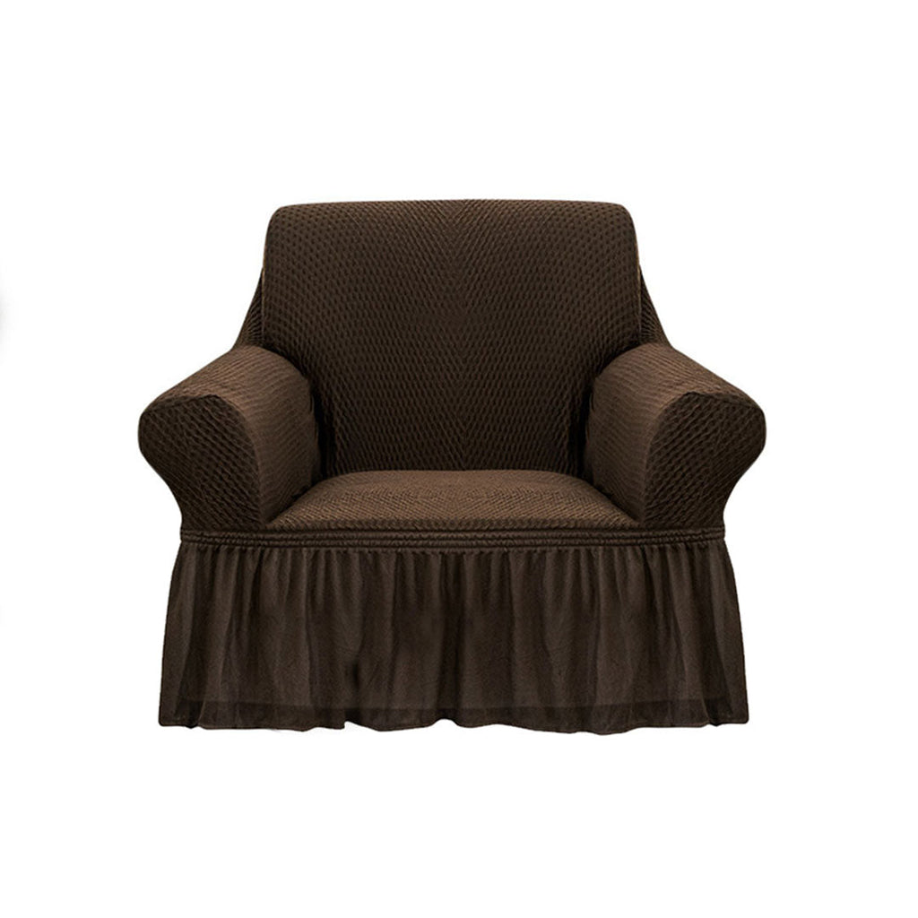 Coffee brown 1-seater sofa cover with ruffled skirt draped over an armchair in a living room.