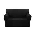 Black 2-seater high stretch sofa cover protecting a living room couch from spills and stains