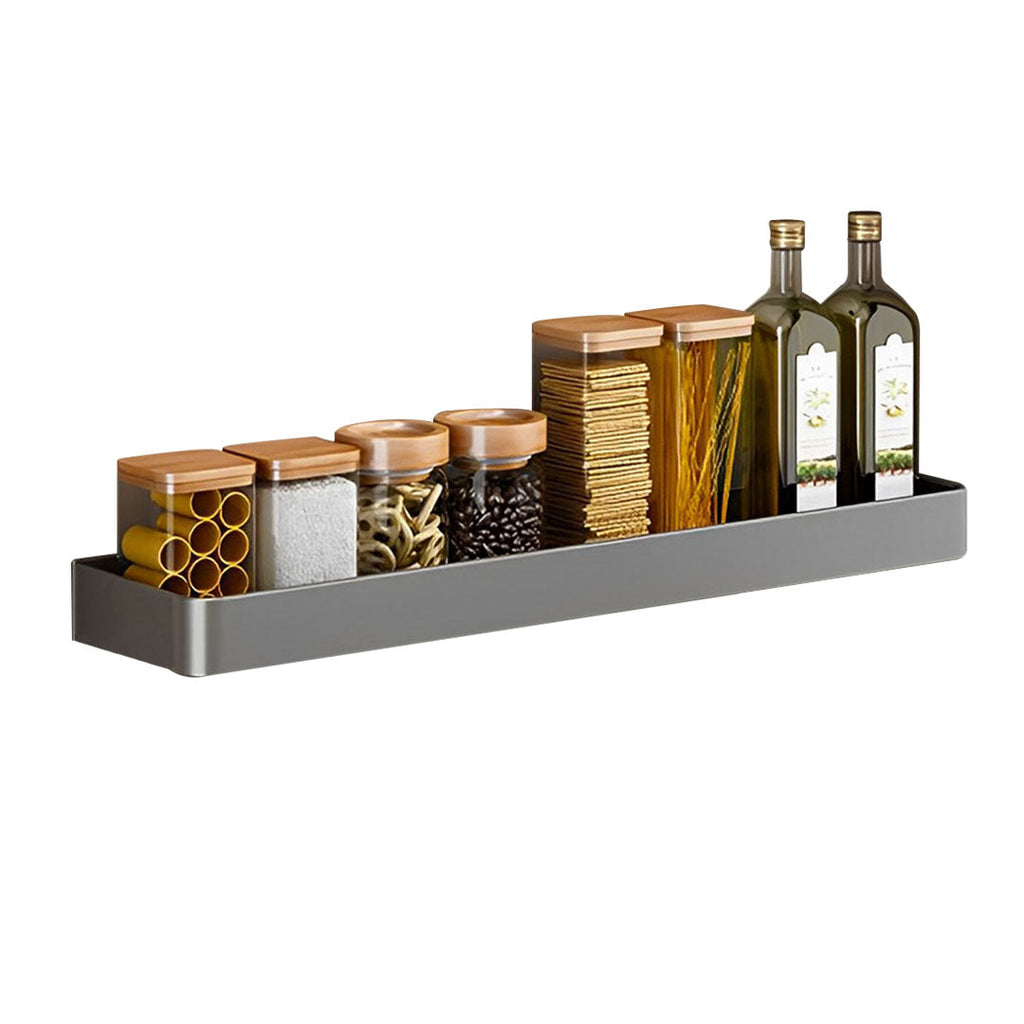Black wall-mounted aluminum spice rack holding kitchen condiments and jars on a smooth tile wall.