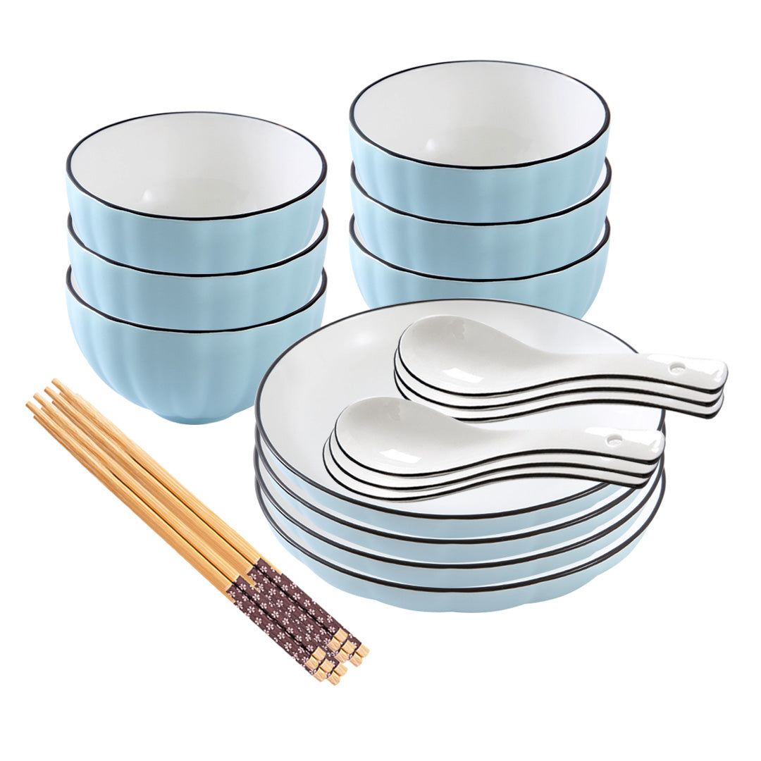 Blue Japanese ceramic dinnerware set with stackable soup bowls, plates, spoons, and chopsticks on table