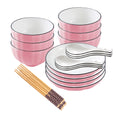 Pink Japanese ceramic dinnerware set including bowls, plates, spoons, and chopsticks on a table