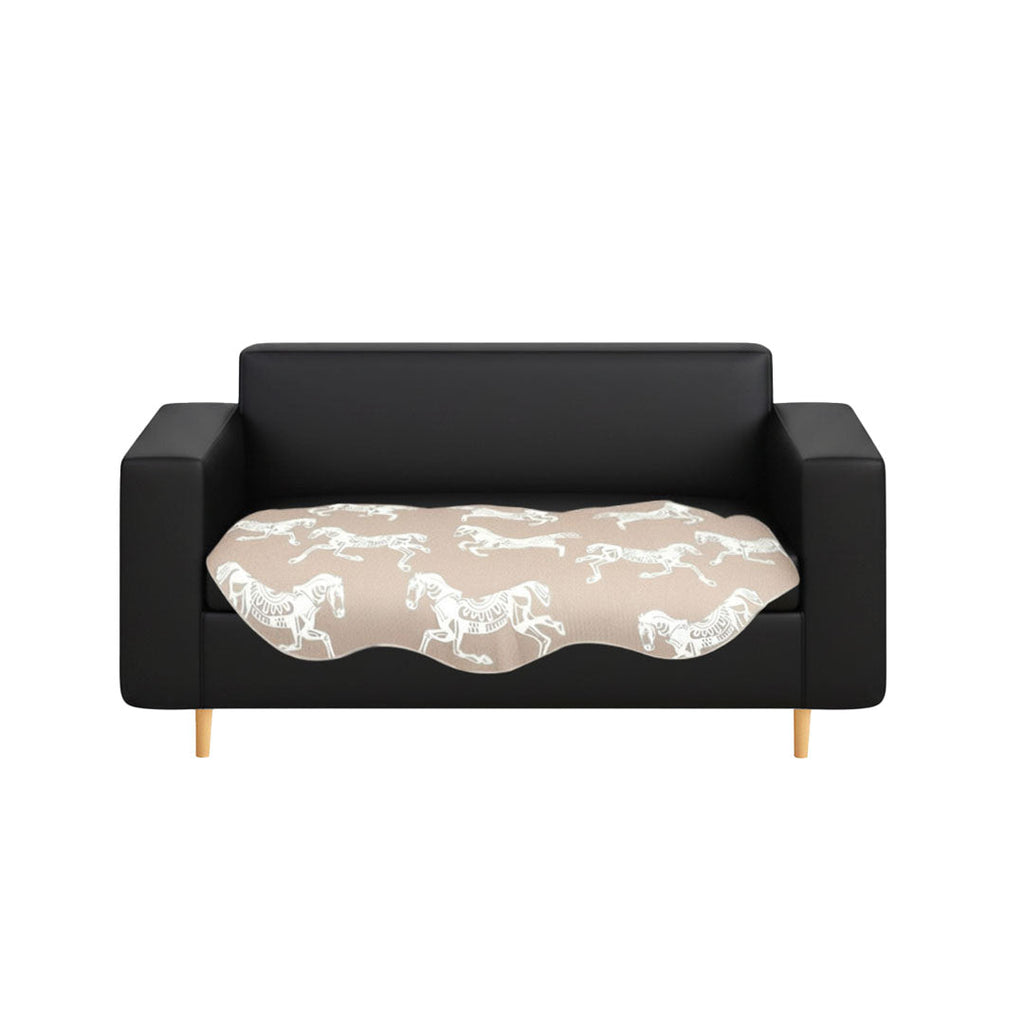 Beige two-seater sofa cover with black horse print draped elegantly over a couch
