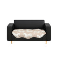 Beige two-seater sofa cover with black horse print draped elegantly over a couch