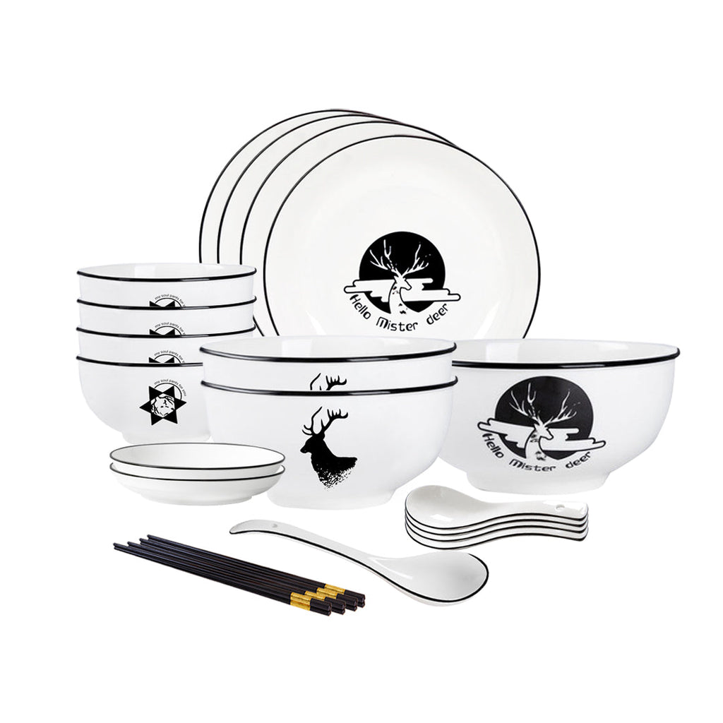 White antler ceramic dinnerware set with bowls, plates, spoons, and chopsticks on a dining table