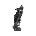 Black abstract resin shush face sculpture with an antique bronze finish and fractured texture.