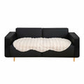 White faux fur throw blanket protecting a large four seater living room sofa