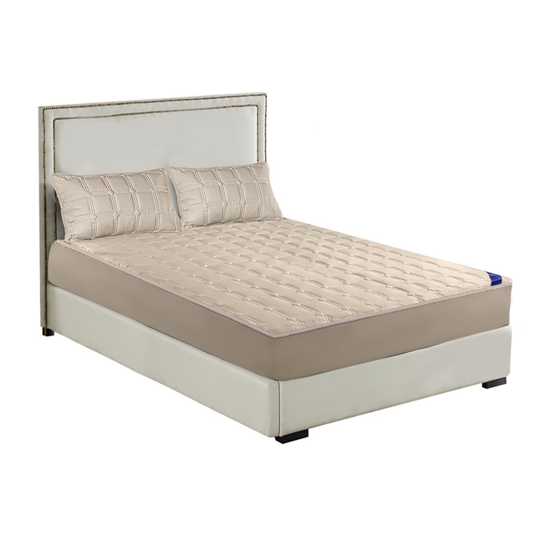 Beige quilted stretchable mattress cover and two matching pillow cases displayed on a bed.