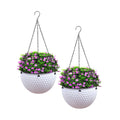 White resin hanging planters set of two, featuring metal suspension chains and built-in drainage holes.