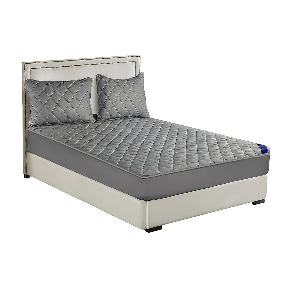 Grey cross-hatch quilted mattress cover and two matching pillowcases on a modern bed