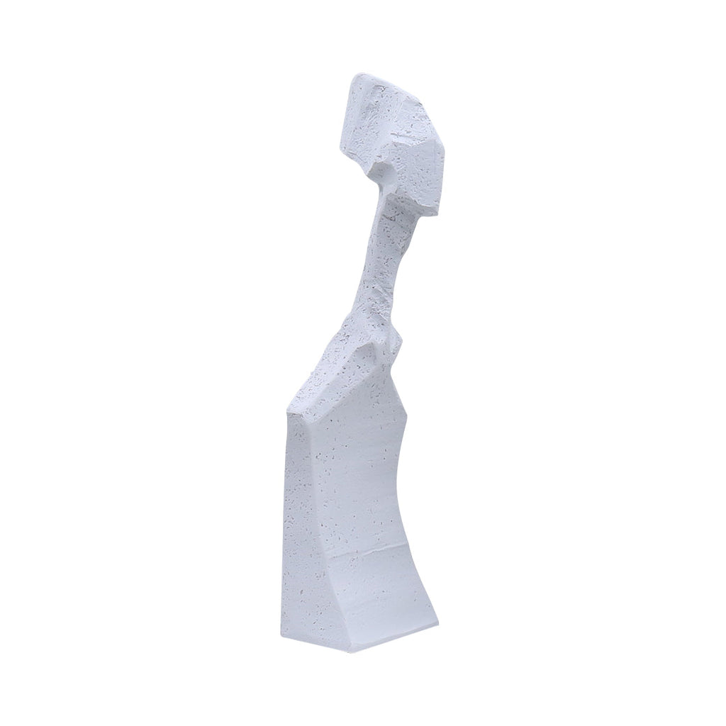 White resin abstract sculpture with modern angular design on display in a minimalist home decor setting
