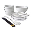 White minimalist ceramic dinnerware set including soup bowls, plates, spoons, and chopsticks