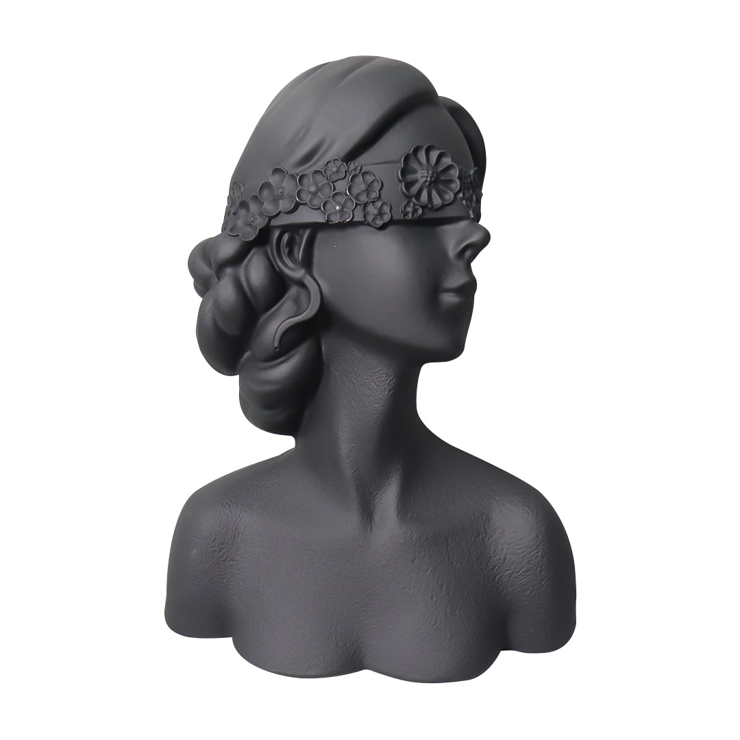 Matte black resin bust sculpture of a blindfolded lady with delicate floral crown detailing.