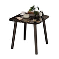 Black stone-patterned side table with sleek pine wood legs in a modern minimalist living room.