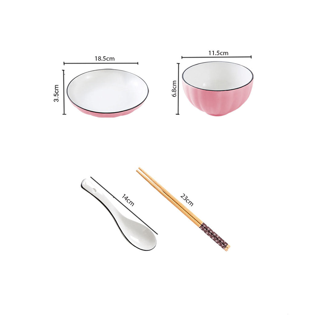 Pink Japanese ceramic dinnerware set including bowls, plates, spoons, and chopsticks on a table — view 2