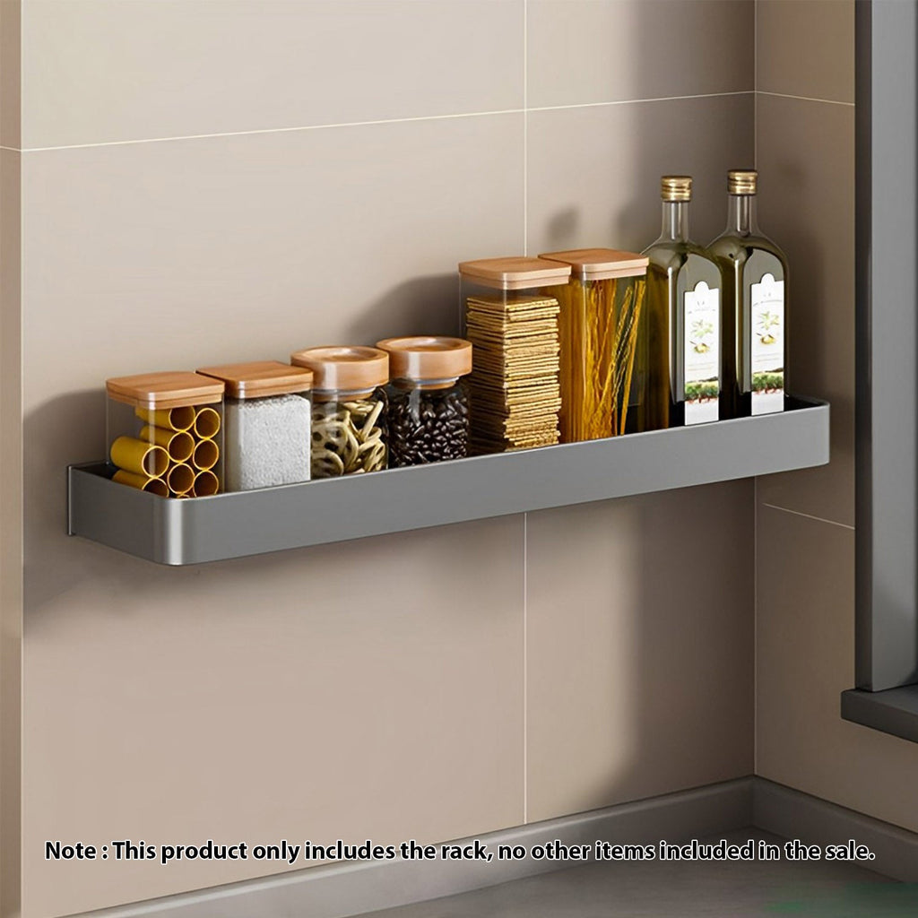 Black wall-mounted aluminum spice rack holding kitchen condiments and jars on a smooth tile wall. — view 2