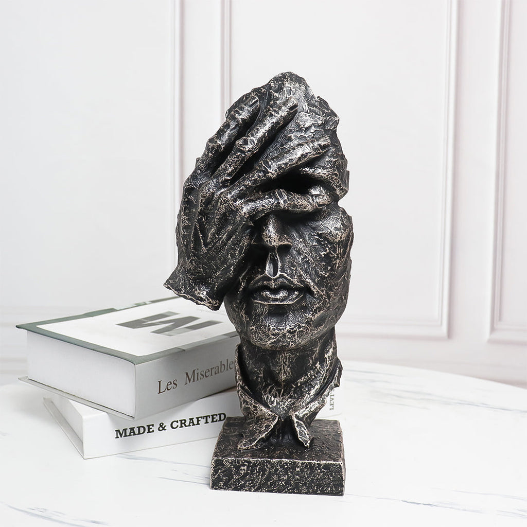 Abstract face sculpture in antique bronze black resin with a hand-over-eyes modern design. — view 2