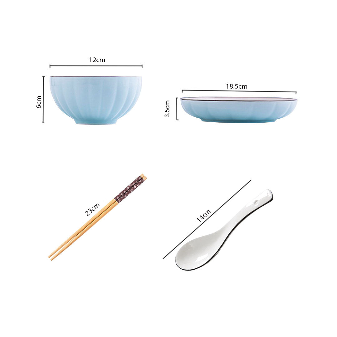 Blue Japanese ceramic dinnerware set with stackable soup bowls, plates, spoons, and chopsticks on table — view 2
