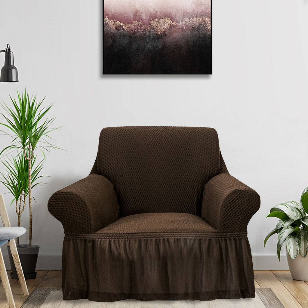 Coffee brown 1-seater sofa cover with ruffled skirt draped over an armchair in a living room. — view 2