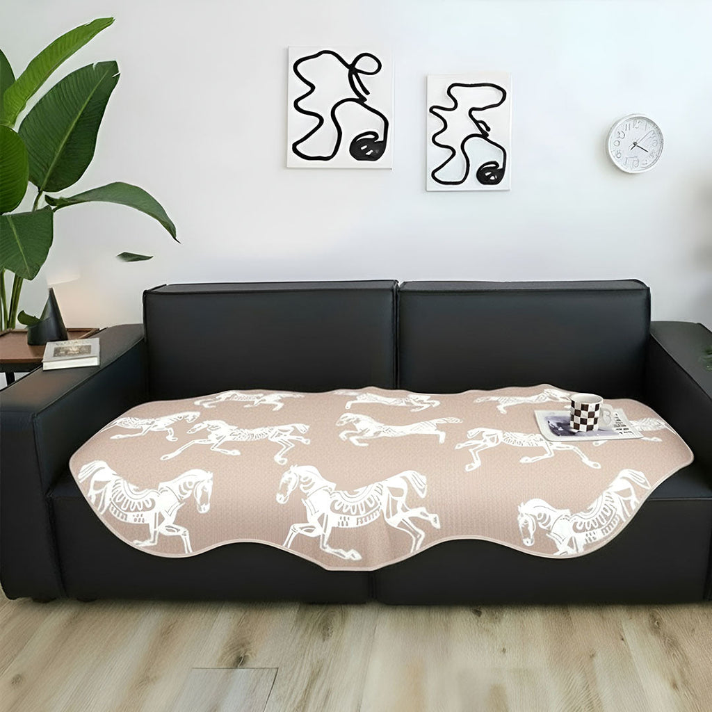 Beige two-seater sofa cover with black horse print draped elegantly over a couch — view 2