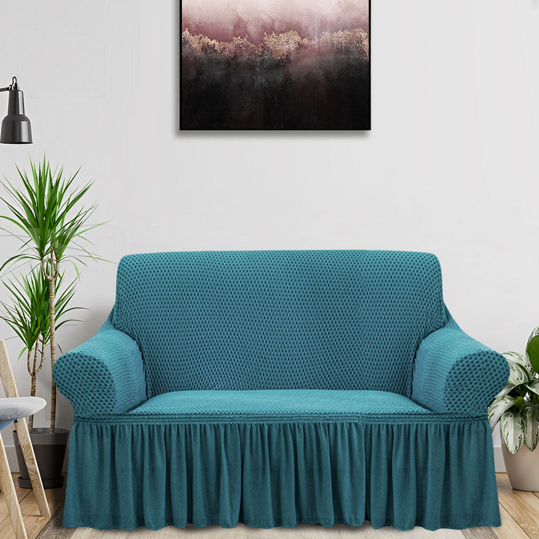 Blue high-stretch 2-seater sofa cover with elegant ruffled skirt protecting a living room couch — view 2