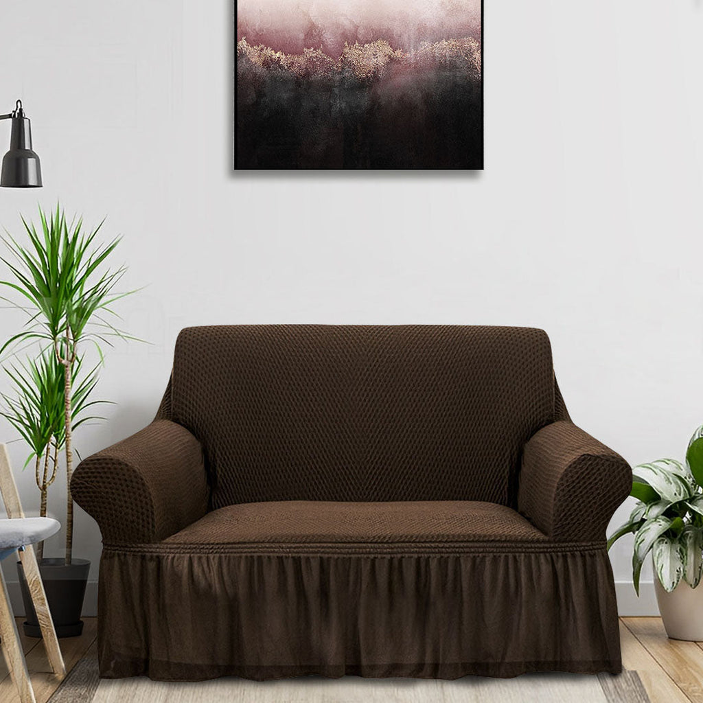 Coffee brown two-seater high stretch sofa cover with ruffled skirt protecting a living room couch — view 2