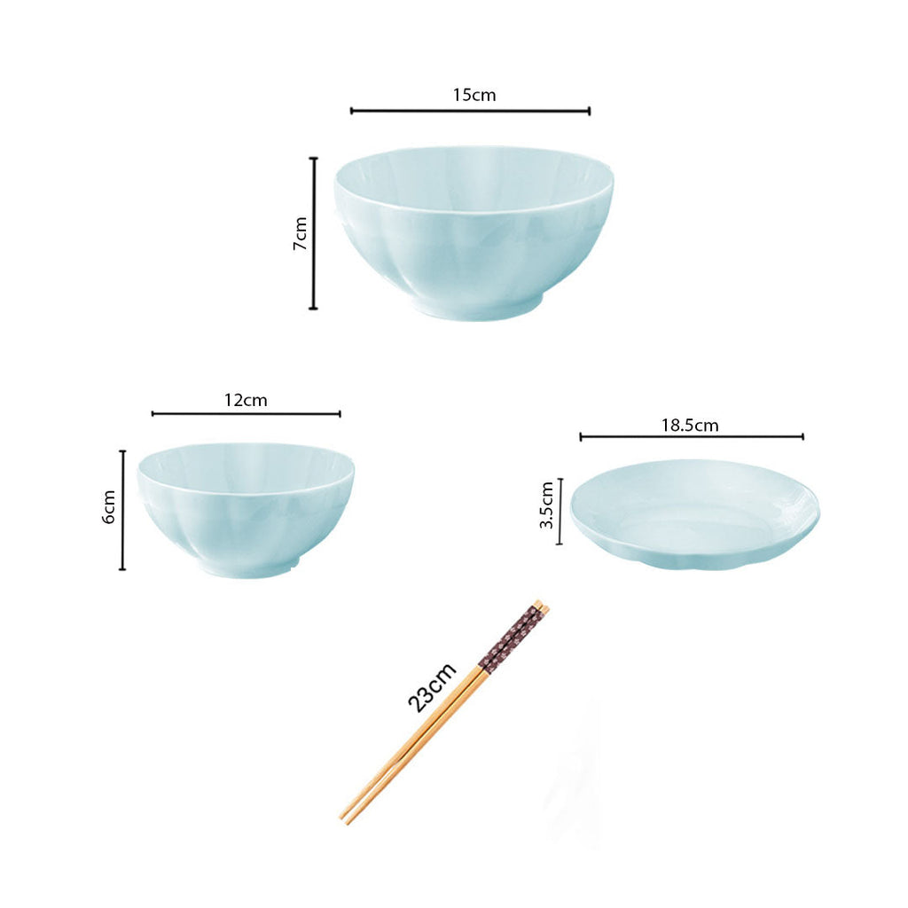 Light blue Japanese style ceramic dinnerware set with bowls plates and chopsticks on a table — view 2