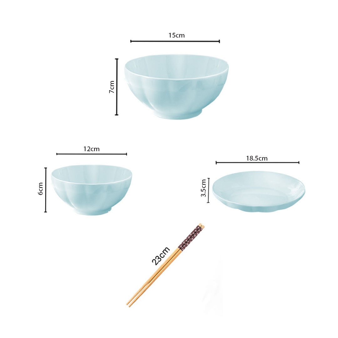 Light blue Japanese style ceramic dinnerware set with bowls plates and chopsticks on a table — view 2