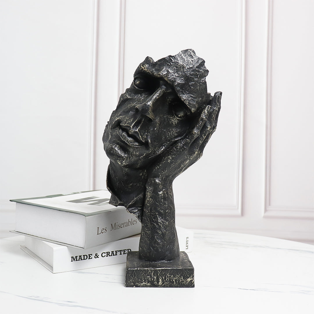 Black resin face sculpture of a thoughtful tilted head resting on a hand, antique bronze finish — view 2