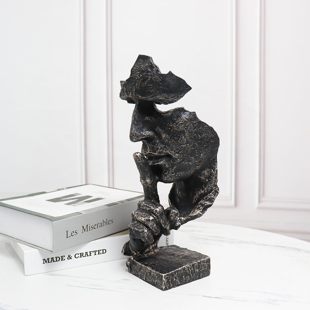 Black abstract resin shush face sculpture with an antique bronze finish and fractured texture. — view 2