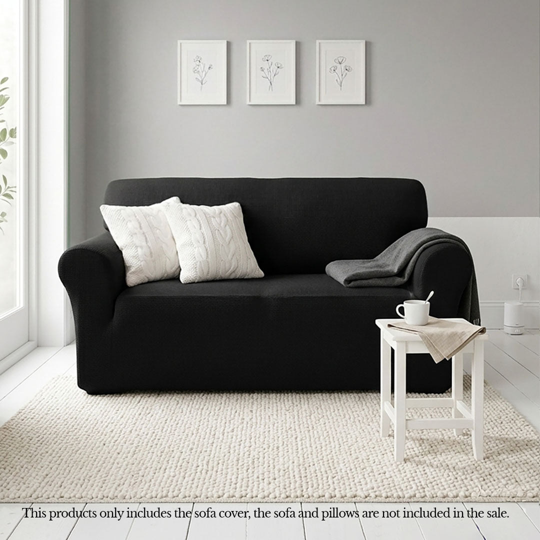 Black 2-seater high stretch sofa cover protecting a living room couch from spills and stains — view 2