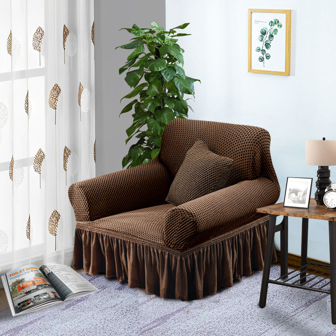 Coffee brown 1-seater sofa cover with ruffled skirt draped over an armchair in a living room. — view 3