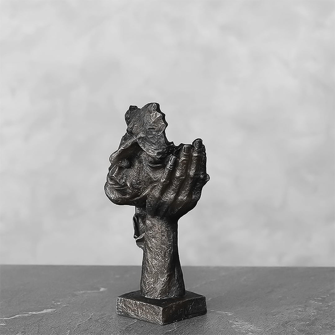 Black resin face sculpture of a thoughtful tilted head resting on a hand, antique bronze finish — view 3