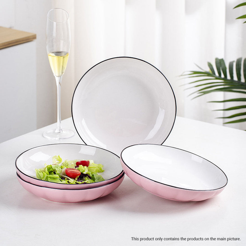 Pink Japanese ceramic dinnerware set including bowls, plates, spoons, and chopsticks on a table — view 3