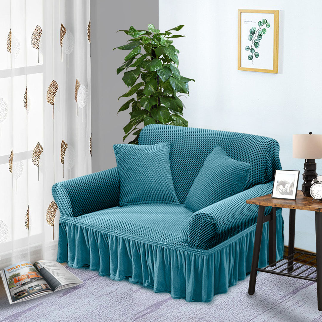 Blue high-stretch 2-seater sofa cover with elegant ruffled skirt protecting a living room couch — view 3
