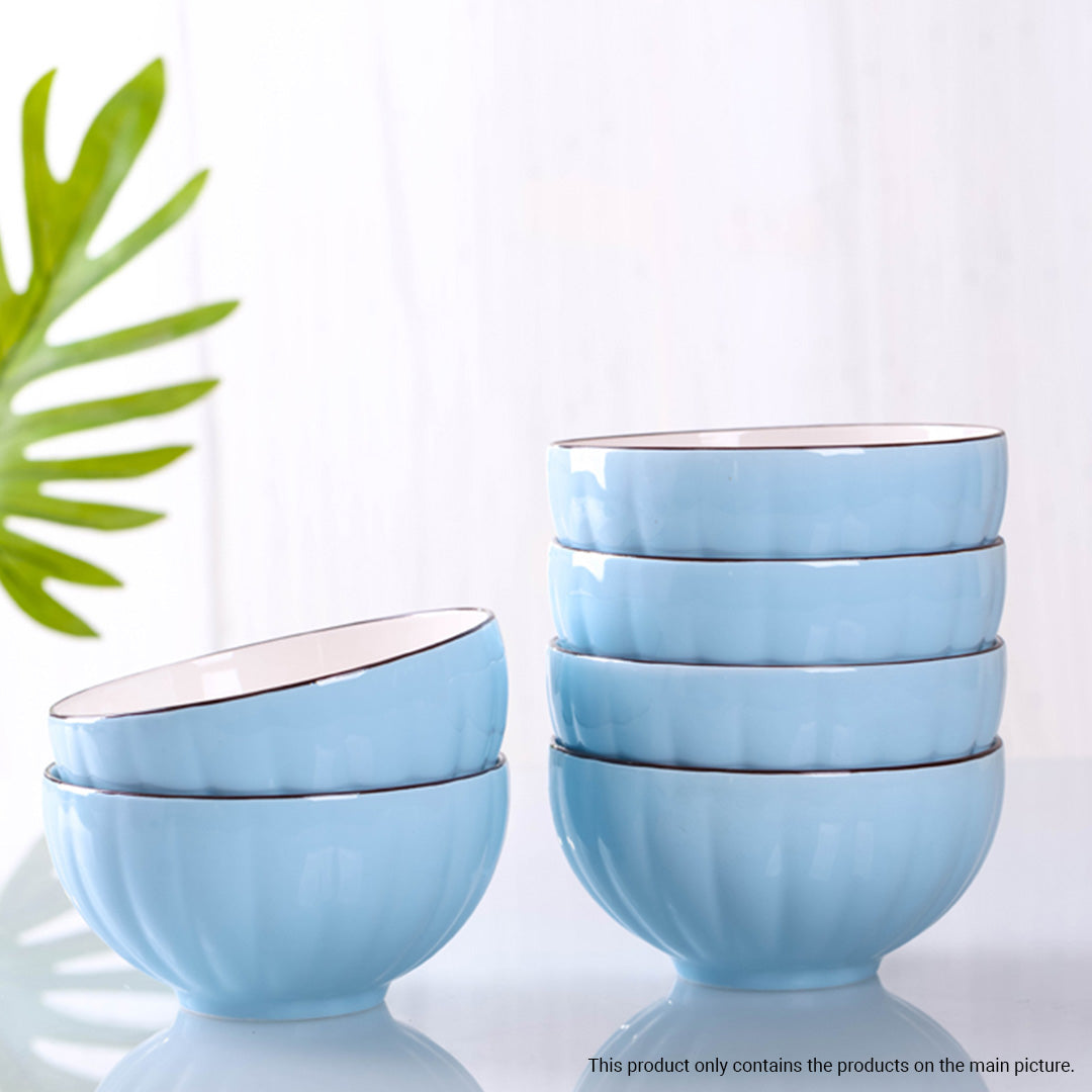 Blue Japanese ceramic dinnerware set with stackable soup bowls, plates, spoons, and chopsticks on table — view 3