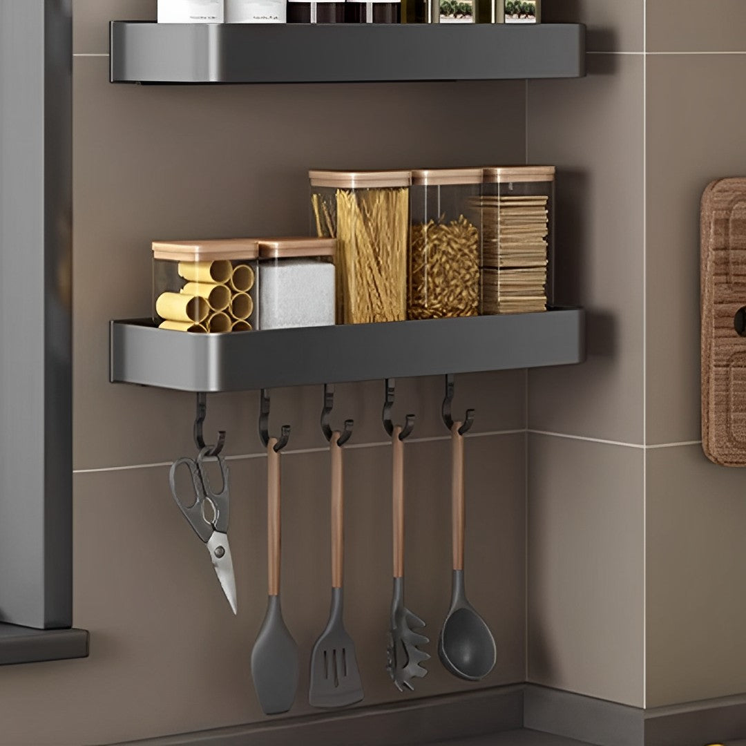 Black wall-mounted spice rack and utensil organiser made of aluminum on a kitchen wall — view 3