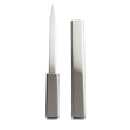 Premium nickel-plated covered letter opener resting elegantly on a modern office desk setup.