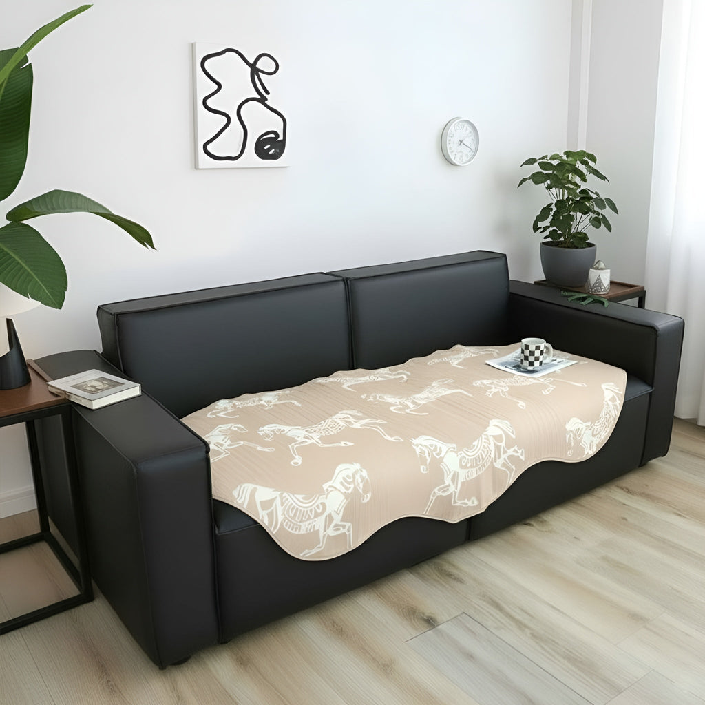 Beige two-seater sofa cover with black horse print draped elegantly over a couch — view 4