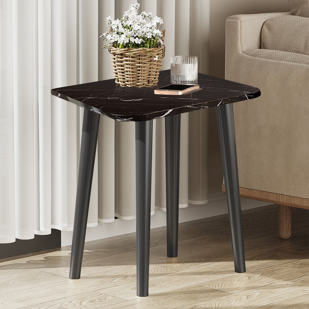 Black stone-patterned side table with sleek pine wood legs in a modern minimalist living room. — view 4