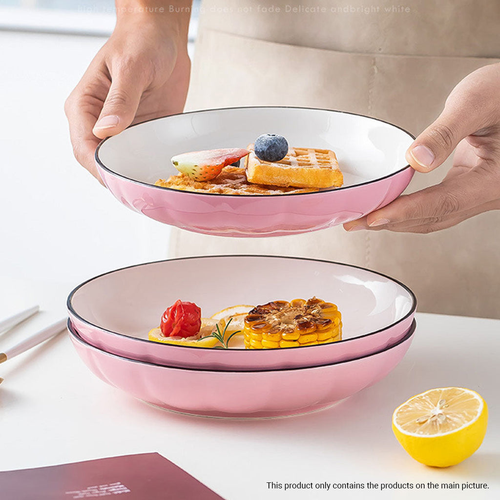 Pink Japanese ceramic dinnerware set including bowls, plates, spoons, and chopsticks on a table — view 5
