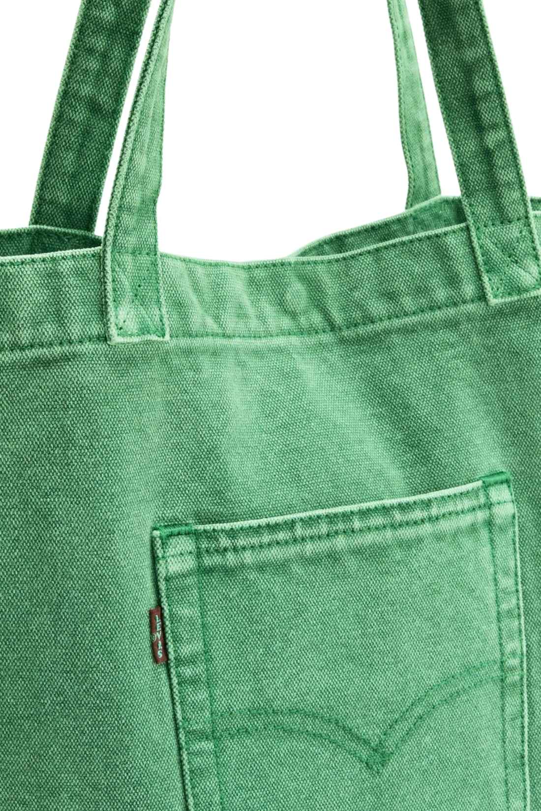 Beige denim tote bag with double handles, snap fastening, front pocket, and red signature label — view 14