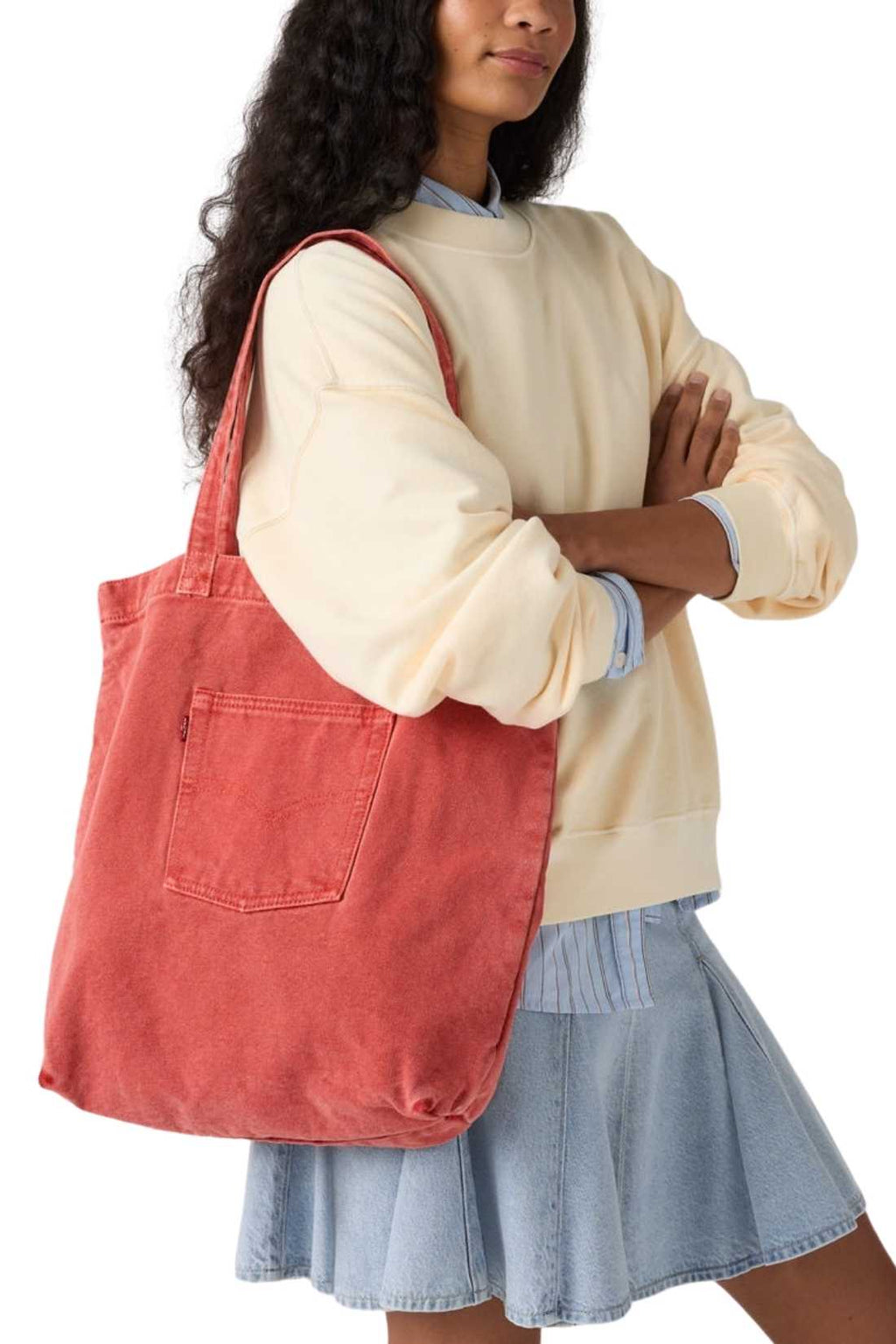 Beige denim tote bag with double handles, snap fastening, front pocket, and red signature label — view 17