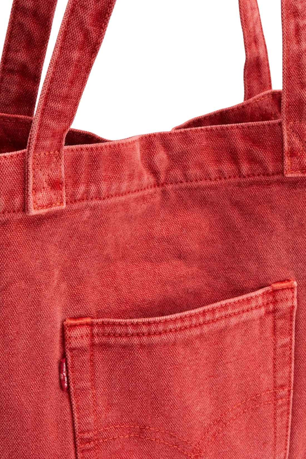Beige denim tote bag with double handles, snap fastening, front pocket, and red signature label — view 19