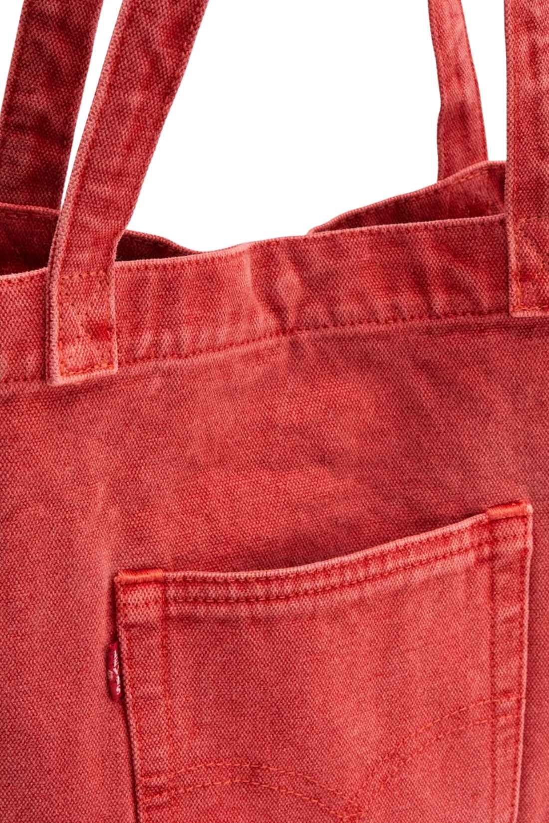Beige denim tote bag with double handles, snap fastening, front pocket, and red signature label — view 19
