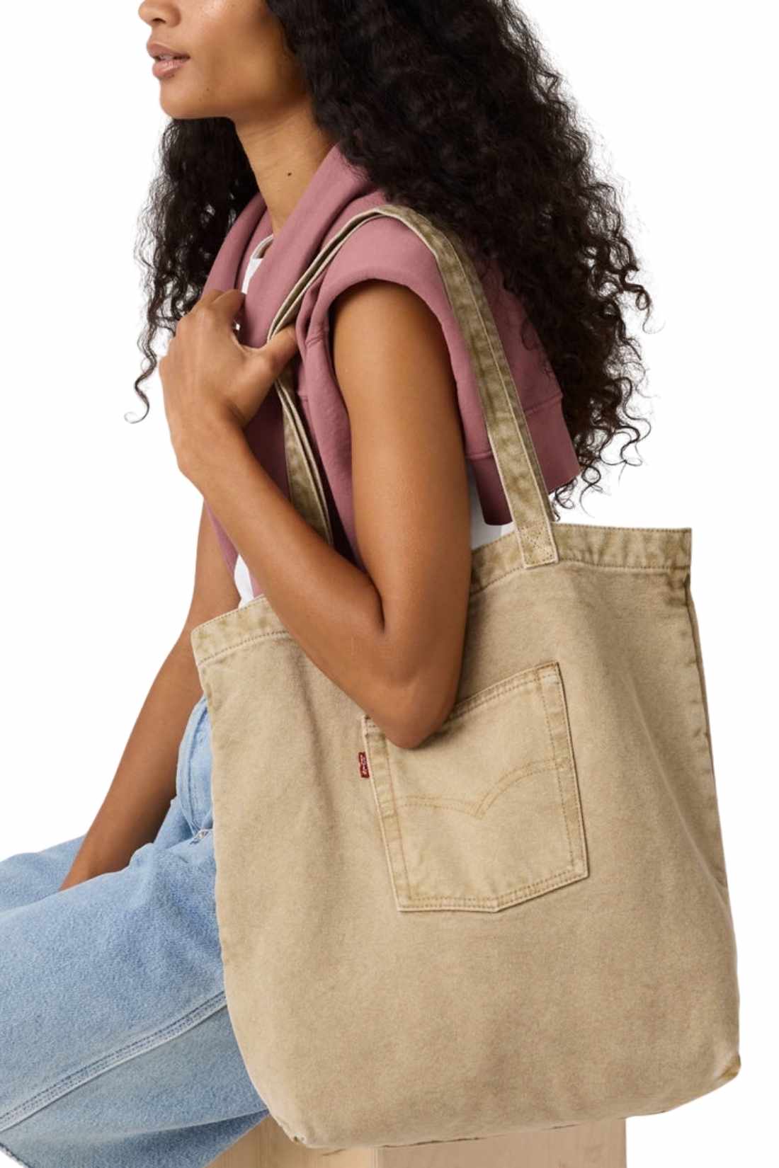 Beige denim tote bag with double handles, snap fastening, front pocket, and red signature label — view 22
